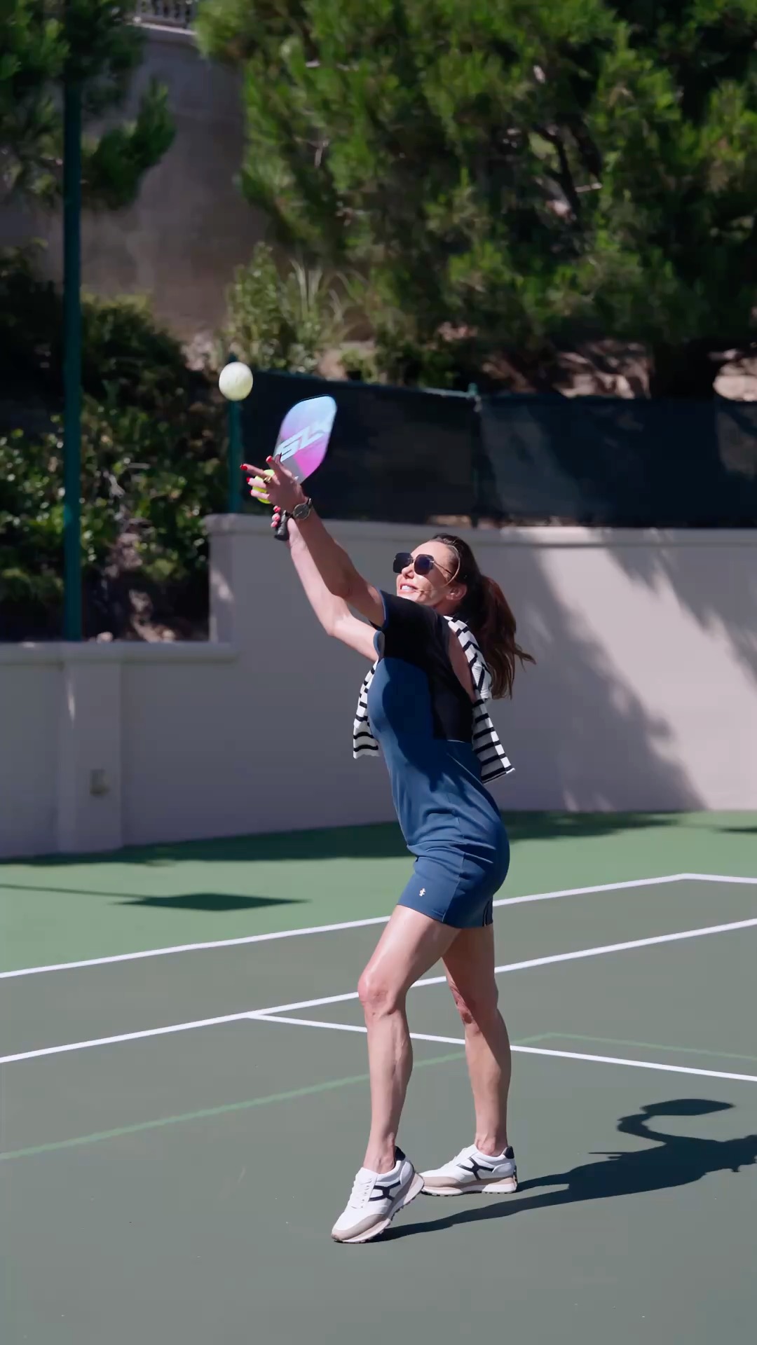 Playing on the estate's private lit tennis court